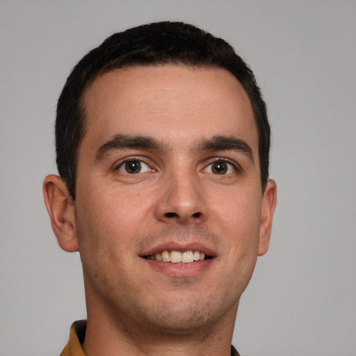 Joyful white young-adult male with short  brown hair and brown eyes