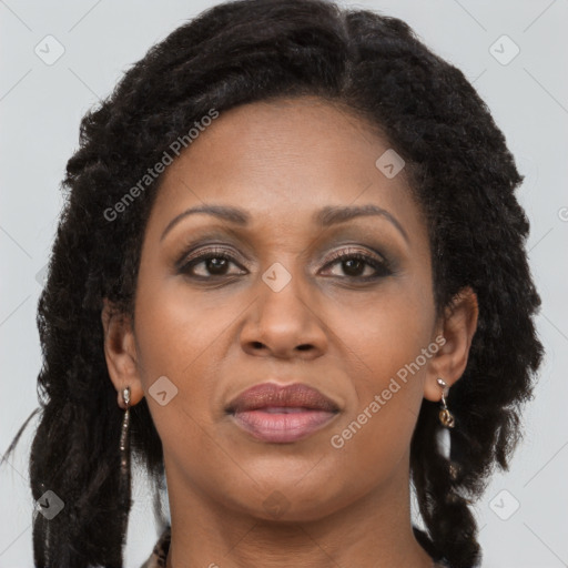 Joyful black adult female with long  brown hair and brown eyes