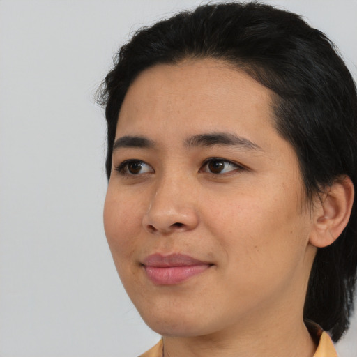 Joyful asian young-adult female with medium  black hair and brown eyes