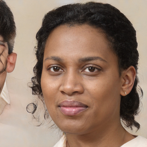 Joyful black young-adult female with medium  brown hair and brown eyes
