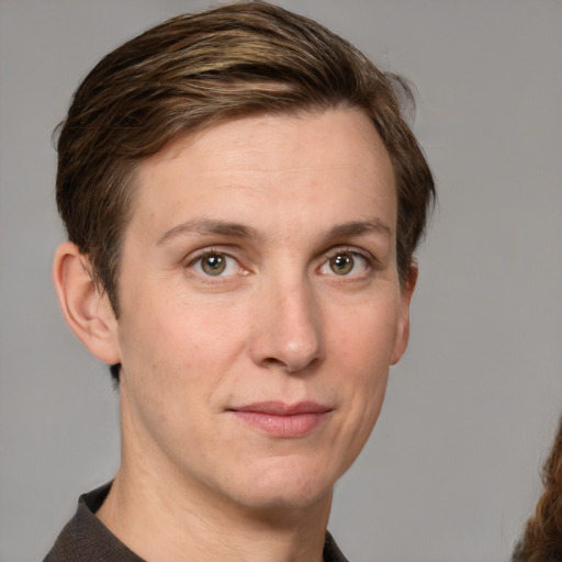 Joyful white adult female with medium  brown hair and grey eyes