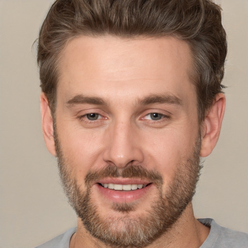 Joyful white adult male with short  brown hair and brown eyes