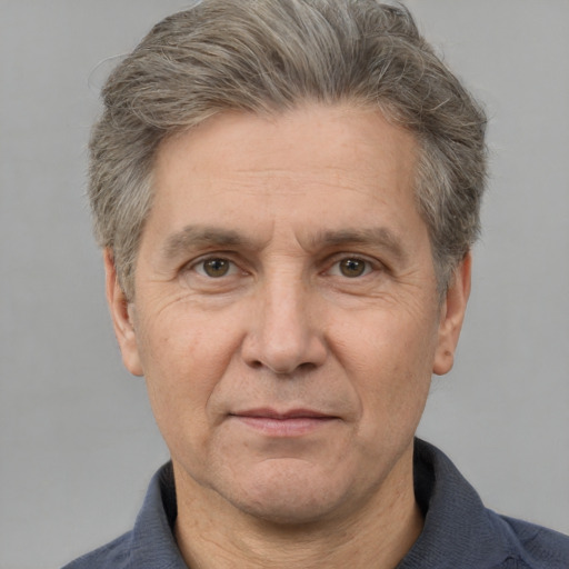 Joyful white middle-aged male with short  gray hair and brown eyes