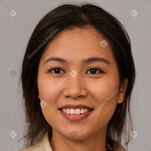 Joyful latino young-adult female with medium  brown hair and brown eyes