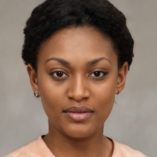 Joyful black young-adult female with short  brown hair and brown eyes