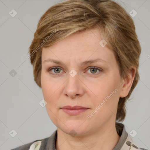 Joyful white adult female with medium  brown hair and grey eyes