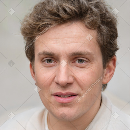 Joyful white adult male with short  brown hair and grey eyes