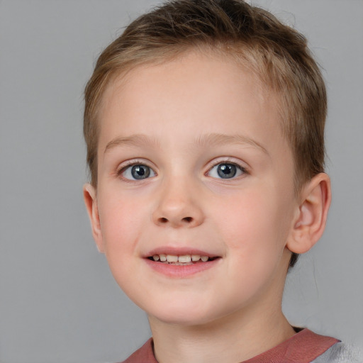 Joyful white child female with short  brown hair and blue eyes