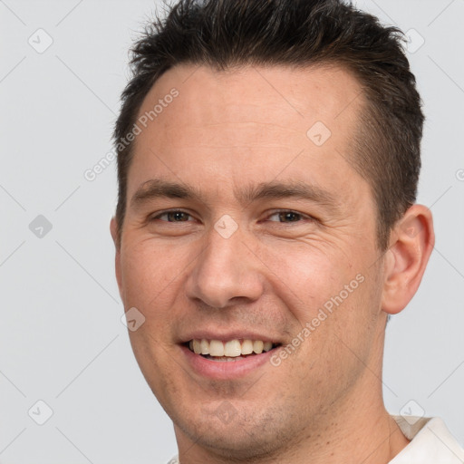 Joyful white young-adult male with short  brown hair and brown eyes