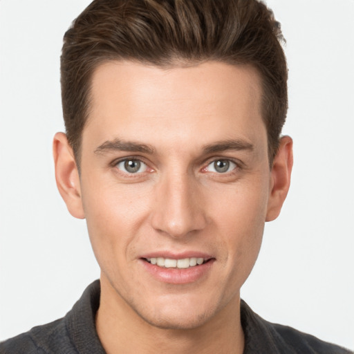 Joyful white young-adult male with short  brown hair and grey eyes