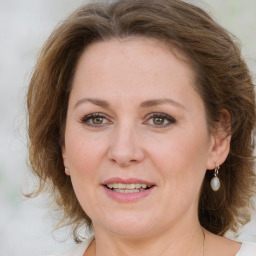 Joyful white young-adult female with medium  brown hair and green eyes