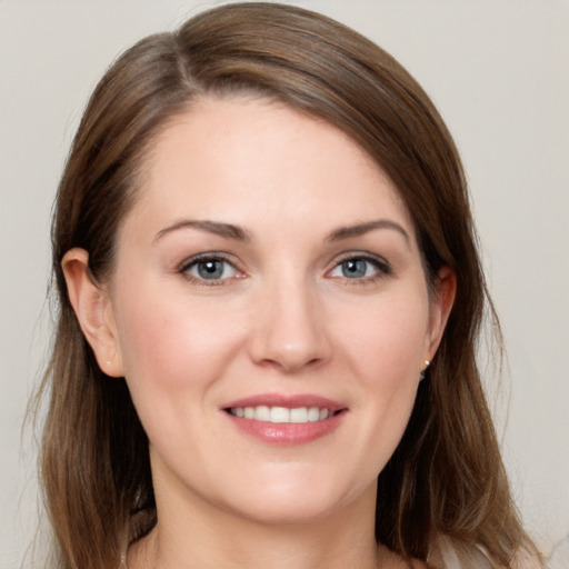 Joyful white young-adult female with long  brown hair and grey eyes