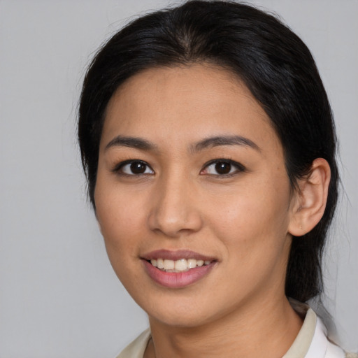 Joyful latino young-adult female with medium  brown hair and brown eyes