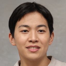 Joyful asian young-adult male with short  brown hair and brown eyes