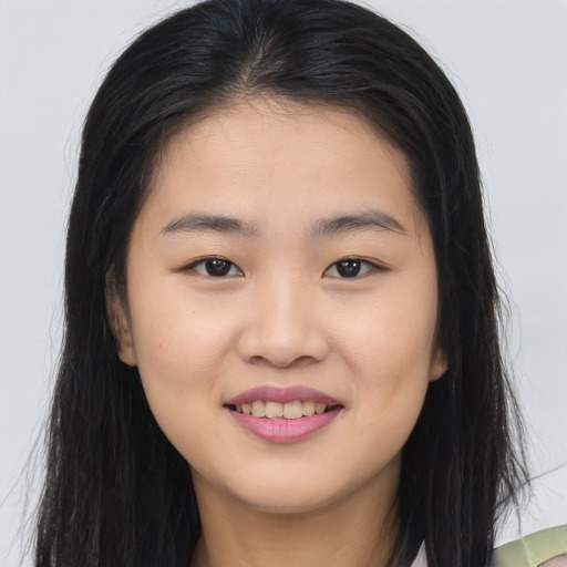 Joyful asian young-adult female with long  brown hair and brown eyes