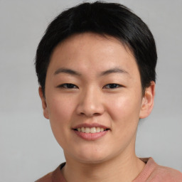 Joyful asian young-adult female with short  brown hair and brown eyes