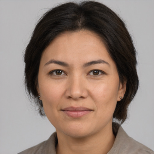 Joyful white adult female with medium  brown hair and brown eyes