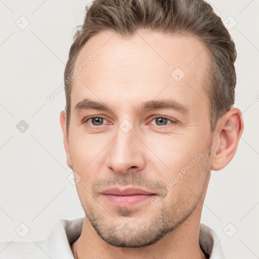 Joyful white young-adult male with short  brown hair and brown eyes