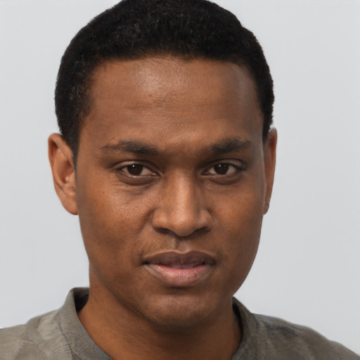 Joyful black young-adult male with short  brown hair and brown eyes