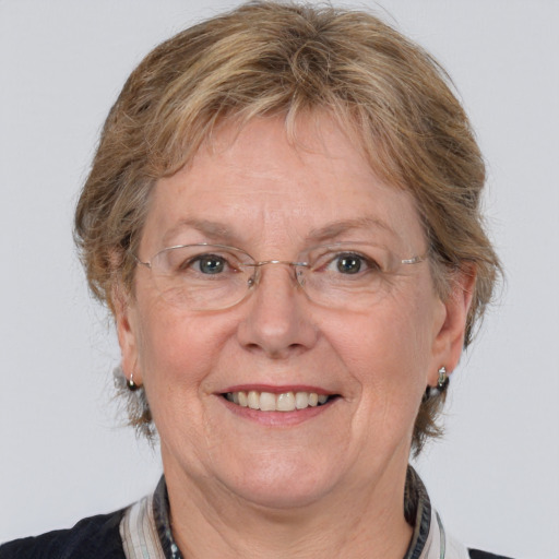 Joyful white middle-aged female with medium  brown hair and grey eyes