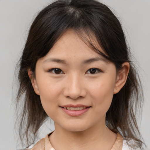 Joyful asian young-adult female with medium  brown hair and brown eyes