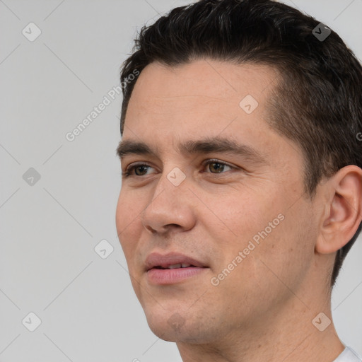 Joyful white young-adult male with short  brown hair and brown eyes