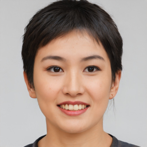 Joyful asian young-adult female with short  brown hair and brown eyes