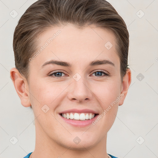 Joyful white young-adult female with short  brown hair and grey eyes