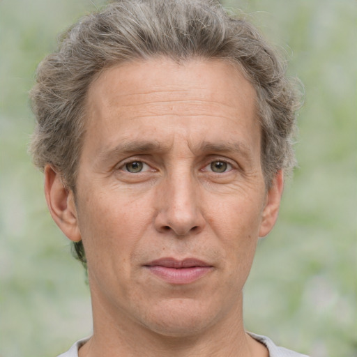 Joyful white middle-aged male with short  brown hair and grey eyes