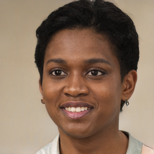 Joyful black young-adult female with short  black hair and brown eyes