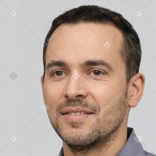 Joyful white adult male with short  black hair and brown eyes