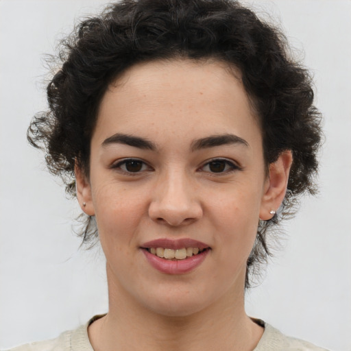 Joyful latino young-adult female with short  brown hair and brown eyes