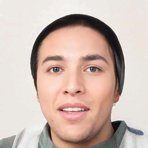 Joyful white young-adult male with short  black hair and brown eyes