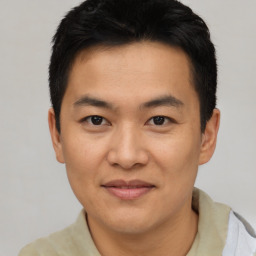 Joyful asian young-adult male with short  black hair and brown eyes