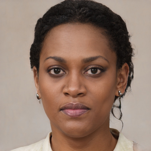 Joyful black young-adult female with short  black hair and brown eyes
