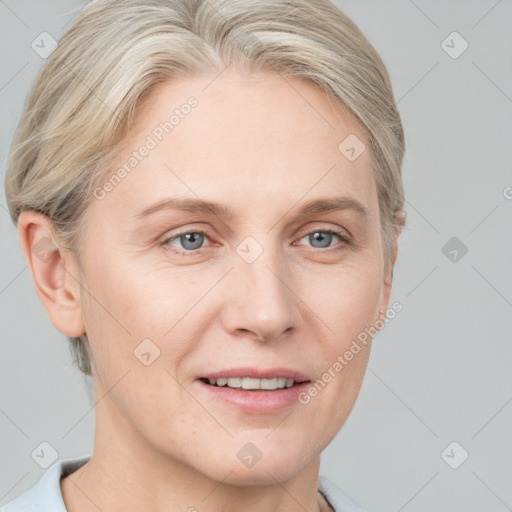 Joyful white adult female with short  brown hair and blue eyes