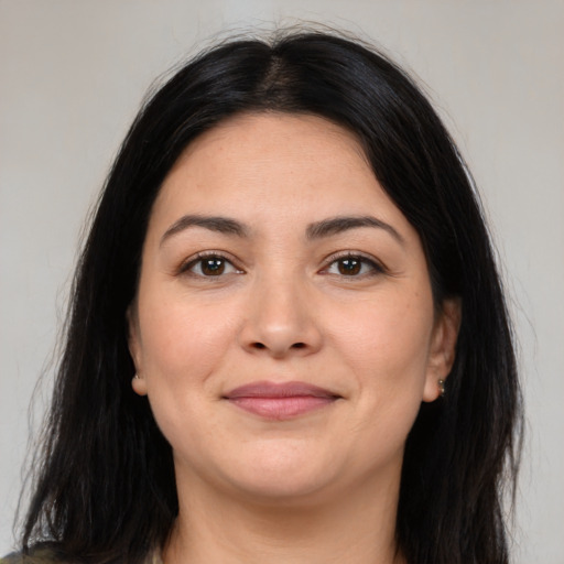 Joyful latino young-adult female with medium  black hair and brown eyes