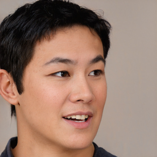 Joyful asian young-adult male with short  brown hair and brown eyes
