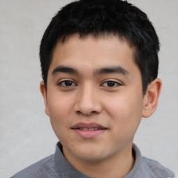 Joyful asian young-adult male with short  black hair and brown eyes