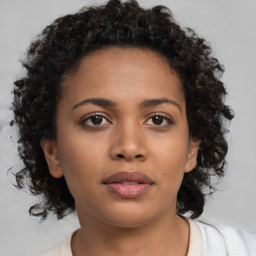 Neutral black young-adult female with medium  brown hair and brown eyes