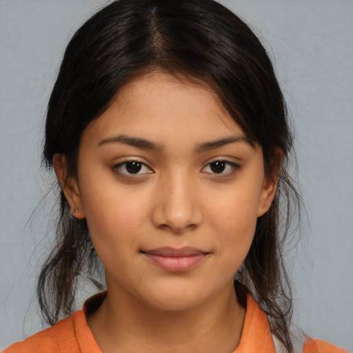 Joyful latino young-adult female with medium  brown hair and brown eyes