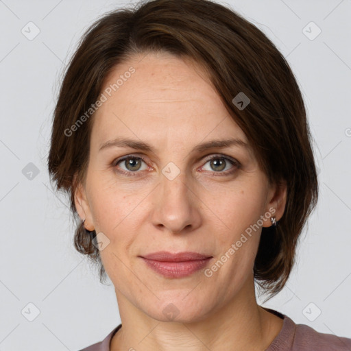 Joyful white adult female with medium  brown hair and grey eyes