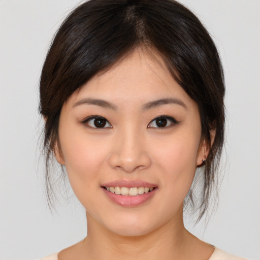 Joyful asian young-adult female with medium  brown hair and brown eyes