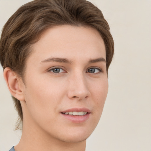 Joyful white young-adult female with short  brown hair and grey eyes