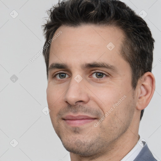 Joyful white adult male with short  brown hair and brown eyes