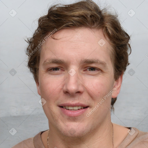 Joyful white adult male with short  brown hair and grey eyes