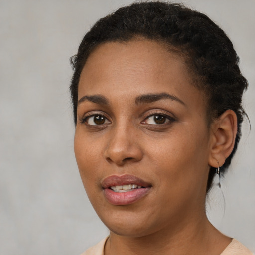 Joyful black young-adult female with short  brown hair and brown eyes