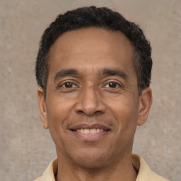 Joyful latino adult male with short  black hair and brown eyes