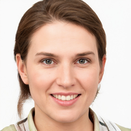 Joyful white young-adult female with medium  brown hair and grey eyes