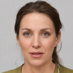 Joyful white adult female with medium  brown hair and grey eyes